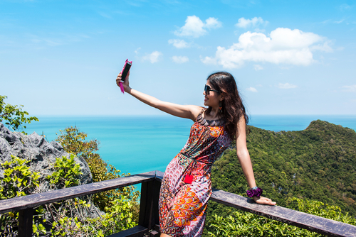 Love and Friends, Ready for your close up, woman taking picture of herself on balcony